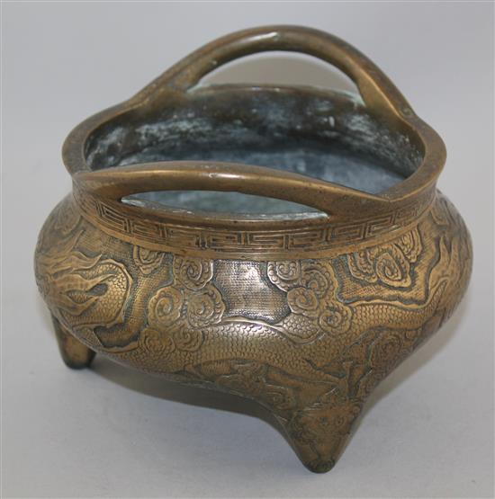 A Chinese bronze tripod censer, Xuande two character mark, 19th century, diam. 18cm, weight 2780g., old repair to base